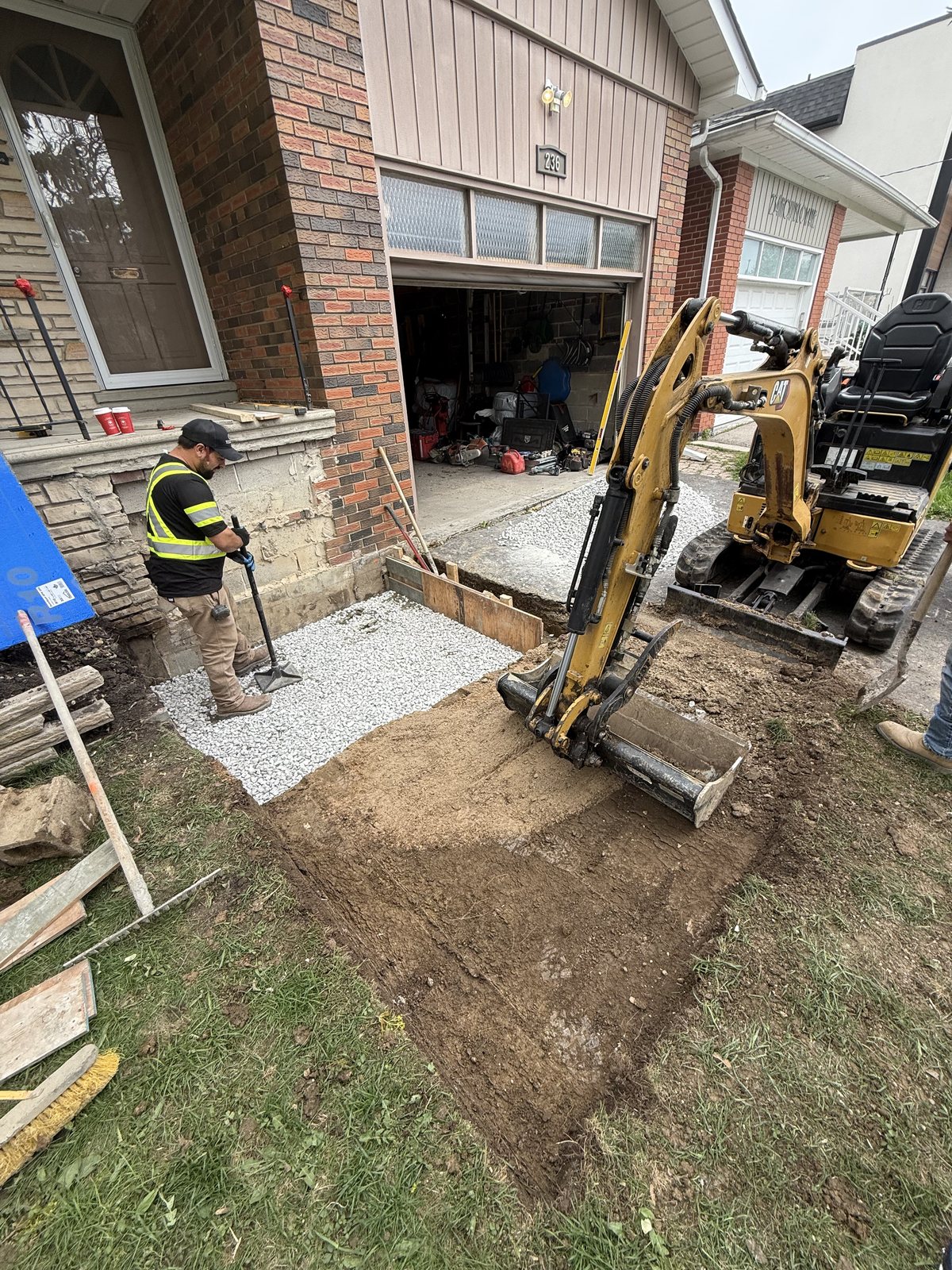 Old concrete broken out and the ground excavated for a compacted stone base