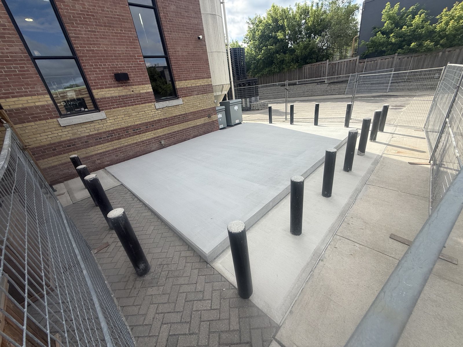 The finished heavy-duty concrete pad with steel bollards