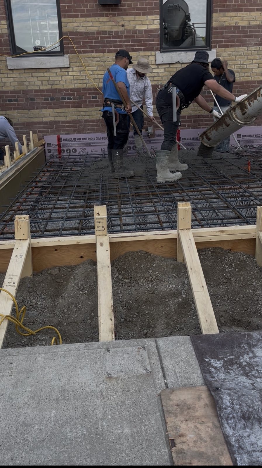 The Concrete Repair Plus crew placing concrete from the chute on a commercial pad