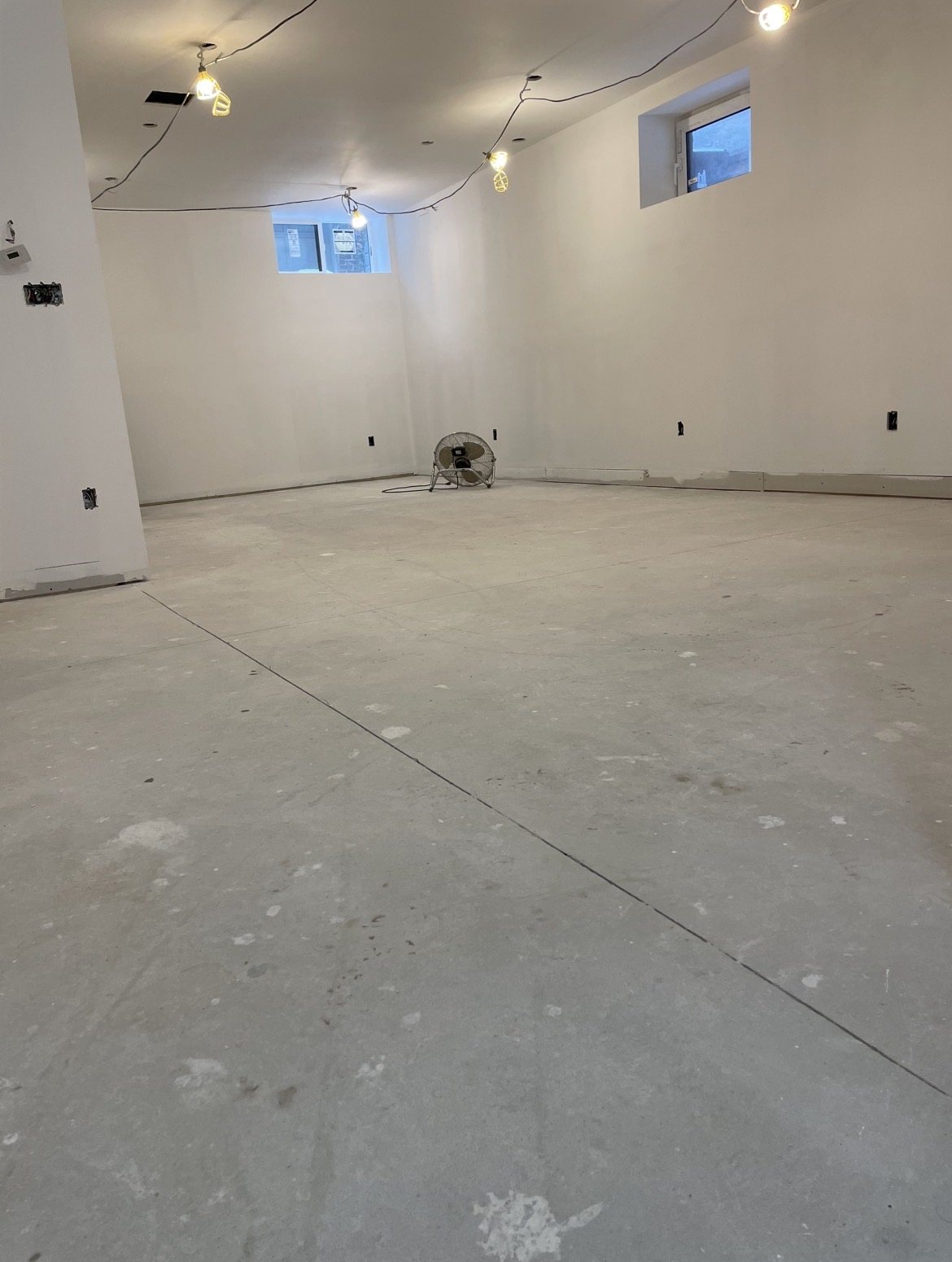 The same Scarborough basement slab before polishing, stained from construction