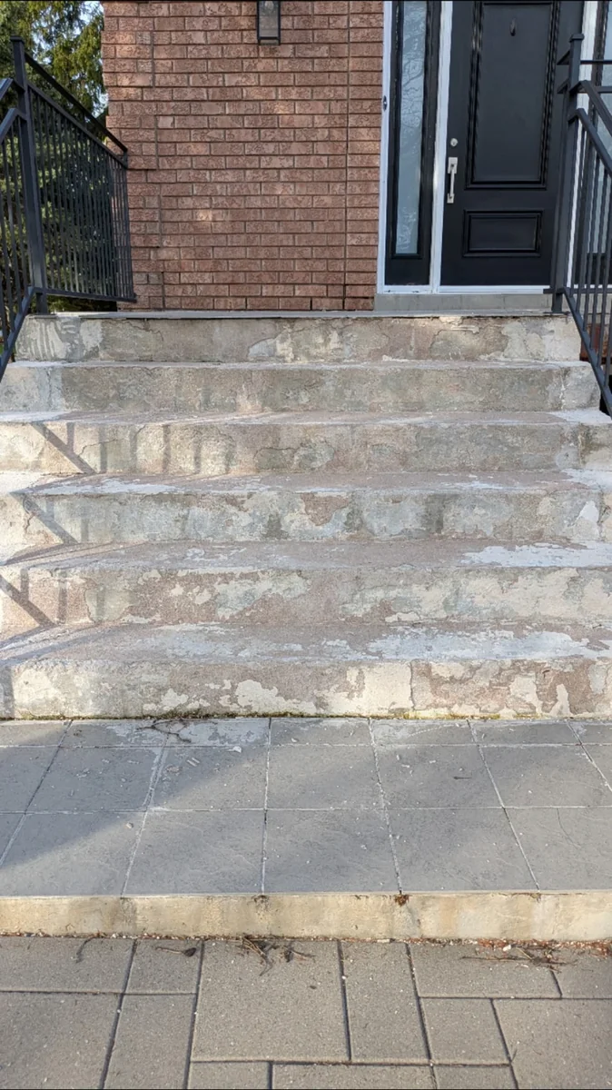 Before — Concrete porch step resurfacing in North York by Concrete Repair Plus. Head-on view of heavily spalled, scaling stair treads and crumbling risers.